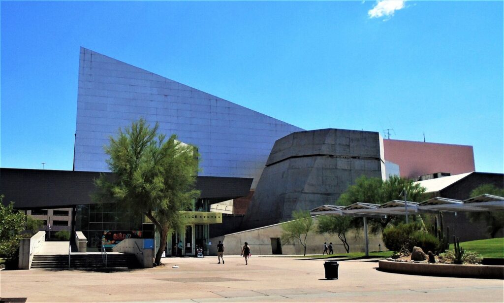 The angular concrete and metal exterior of the Arizona Science Center in downtown Phoenix under a bright blue sky