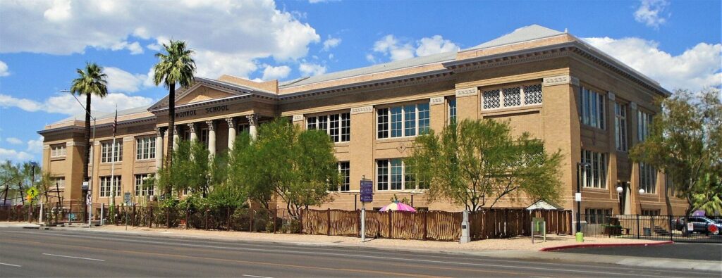 The two-story brick former Monroe School, now the Children's Museum of Phoenix and a top pick among things to do in Phoenix with kids, with palms along the street
