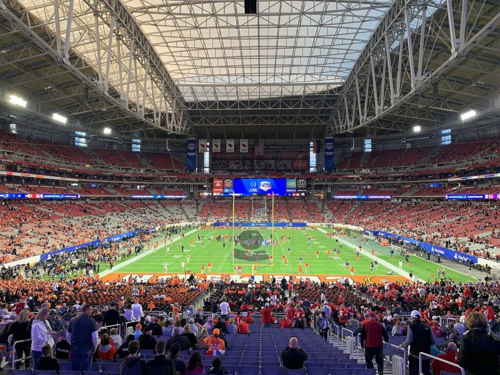 A packed State Farm Stadium under its translucent roof during the Fiesta Bowl
