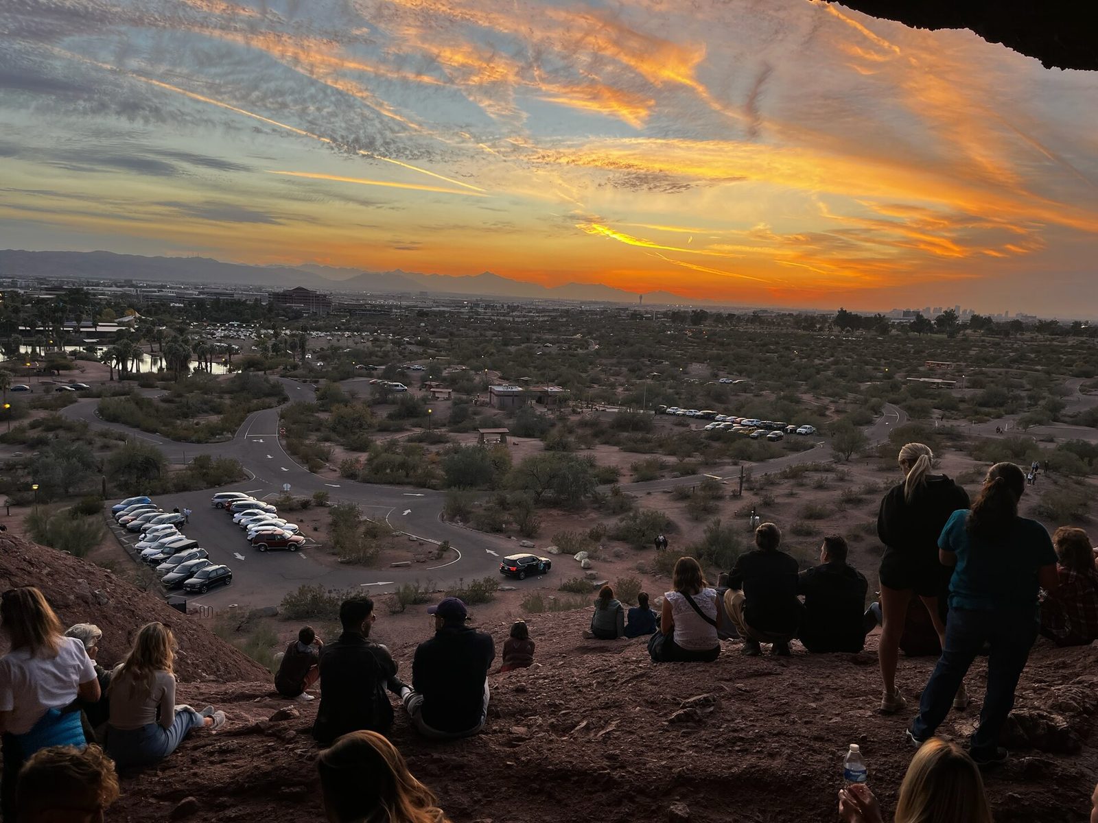 People watching the sunset from inside Hole-in-the-Rock at Papago Park, one of the easiest things to do in Phoenix without a ticket