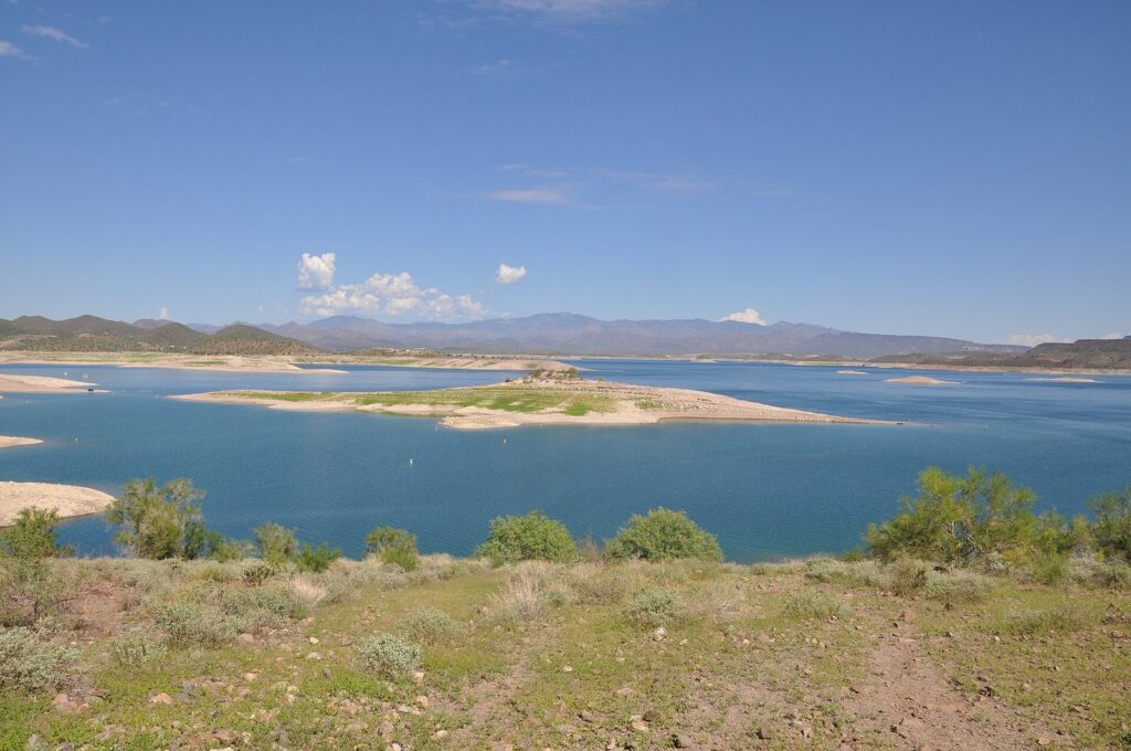 Lake Pleasant's blue water and sandy islands with desert hills beyond, one of the largest lakes near Phoenix