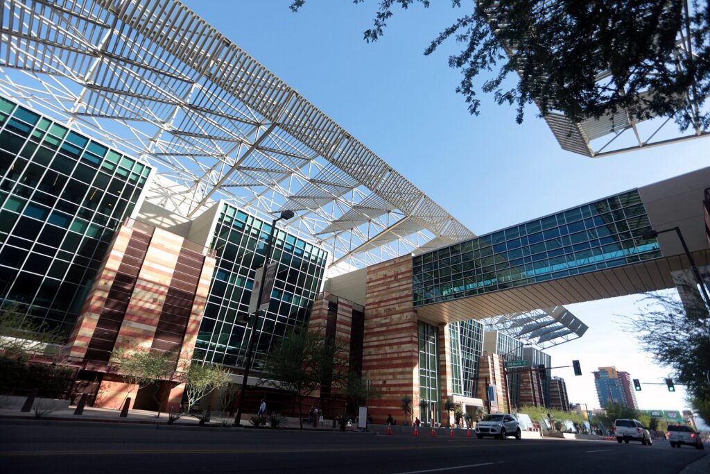 The Phoenix Convention Center's angled steel canopy and glass walls above a downtown street